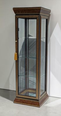 a glass display case with a clock inside of it