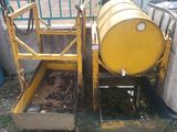a large yellow barrel sitting next to a metal container