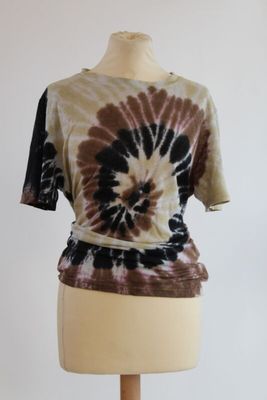 a picture of a mannequin torso with a tie dye shirt on it