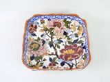 a small square plate with a floral design on it