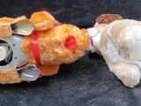 two stuffed animals that are laying next to each other