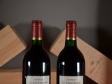 two bottles of wine sitting next to each other on a table