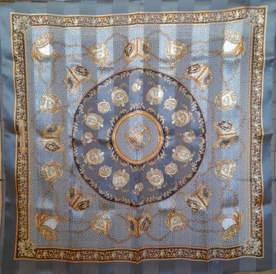an image of a blue and gold scarf with a clock on it