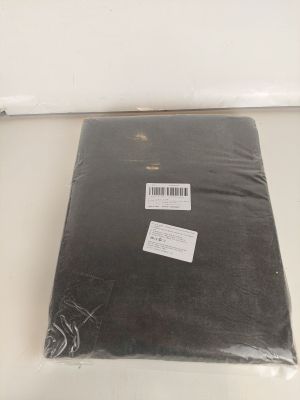 a bag of black fabric sitting on a white table