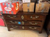a chest of drawers that has boxes on top of it
