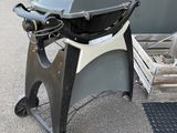 a grill that is sitting in the middle of a parking lot