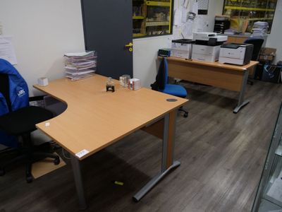 a desk with a backpack on it and a chair in front of it