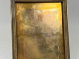 an old picture frame with a gold leaf decoration on it