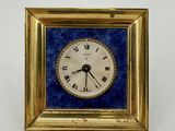 a gold frame with a blue and white clock on it