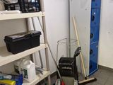 a small room with a blue refrigerator and a blue cart