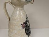 a white vase with a black and red design on it
