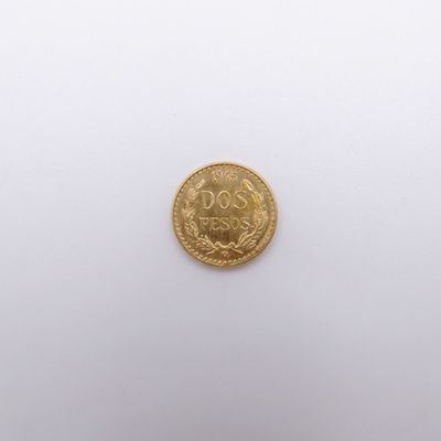 a close up of a gold coin on a white surface