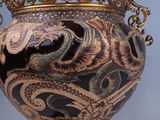 a vase with a dragon on it sitting on a table