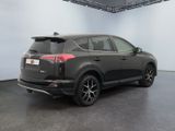 the back of a black toyota rav parked in a garage