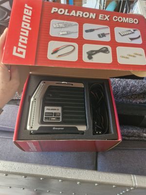 someone is holding a box with some tools inside of it