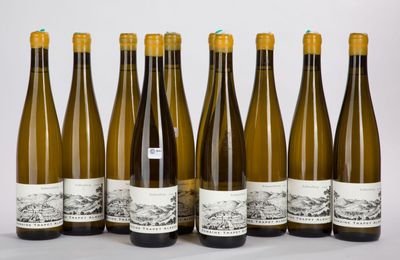six bottles of wine are lined up in a row