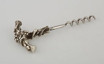 a close up of a bottle opener on a white surface