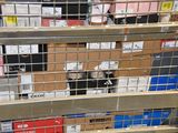many boxes in a metal cage on the floor