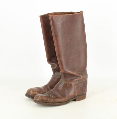 pair of brown leather cowboy boots on a white background