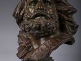 a bronze bust of a bearded man with long hair and a beard