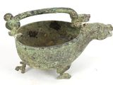 a small metal bowl with a handle on a white surface