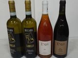 several bottles of wine are lined up on a table