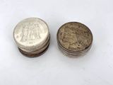 two coins sitting next to each other on a white surface