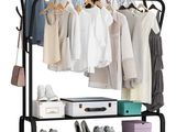 the clothes rack is holding several pairs of shoes and a suitcase