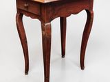 a small wooden table with a drawer underneath it