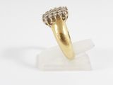 a close up of a gold ring with diamonds on a white surface