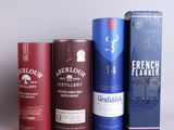 three bottles of different types of alcohol sitting next to each other