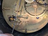 a close up of a clock that is being worked on