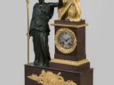 a statue of a man holding a sword and a clock