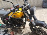 a yellow and black motorcycle parked next to a building