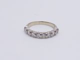 a white gold ring with five diamonds on a white background
