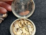 a person holding a pocket watch with a chain attached to it