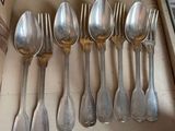 a lot of silver spoons and spoon spoons on a shelf