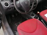the interior of a car with red leather seats and a steering wheel