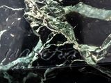a black and white marble table with a lizard on it