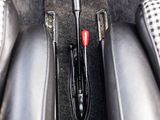 a close up of a car ' s center console with a red button