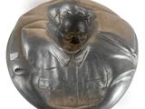 a statue of a man in a suit on a plate