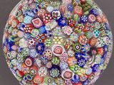 a glass bowl filled with lots of colorful glass beads