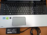 a laptop computer sitting on top of a desk with a charger