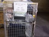 a cage with a mattress on top of it in a warehouse