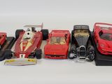 several toy cars are lined up in a row on a white surface