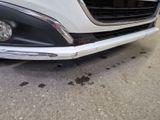 a close up of the front of a car with a dent in it