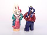two figurines that are standing next to each other