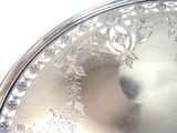 a close up of a silver plate on a table