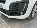 a close up of the front of a white car