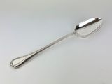 a close up of a spoon on a table with a white background